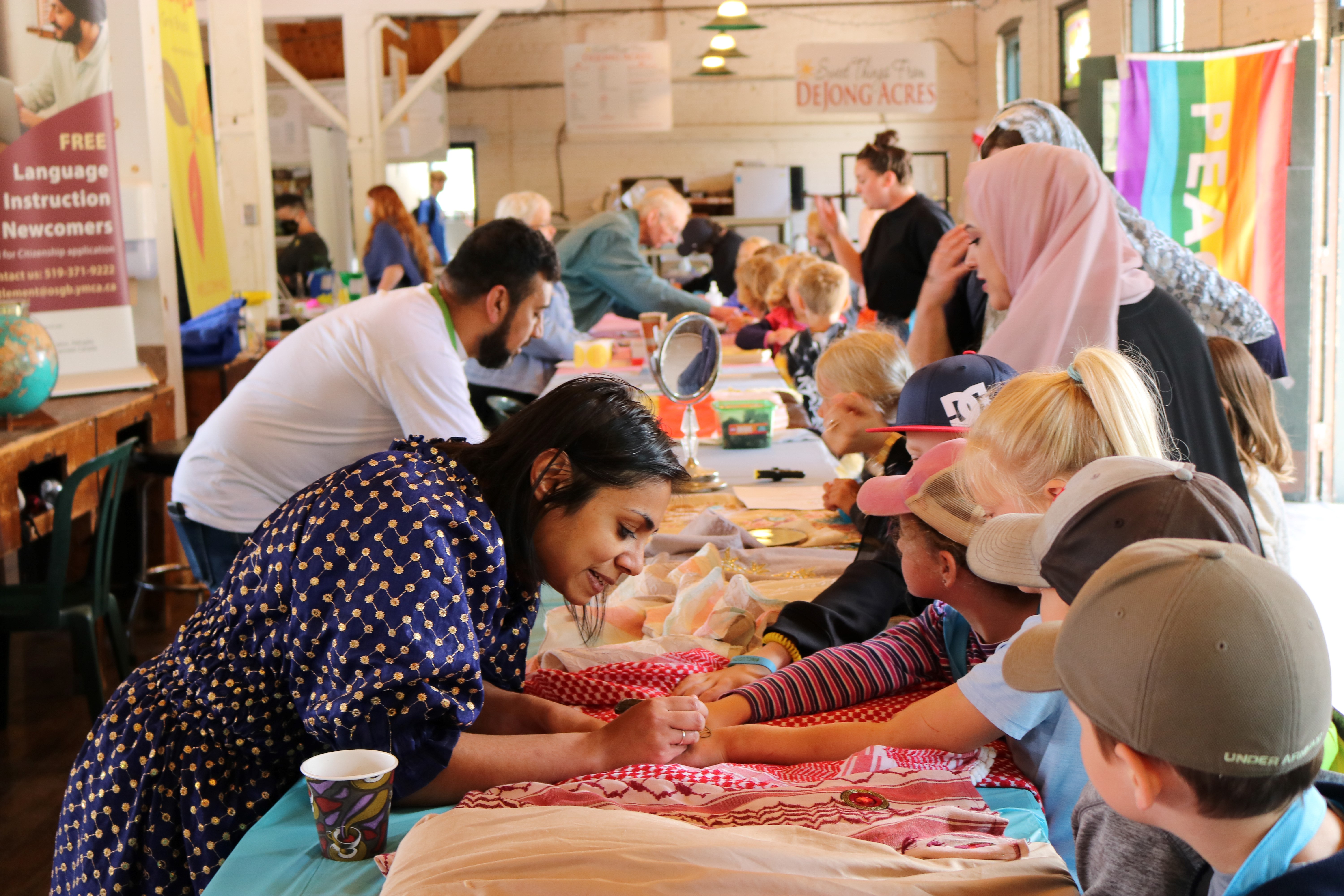 People on either side of table at One World Festival