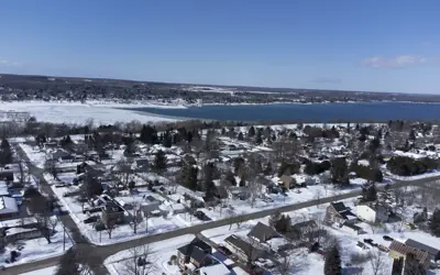 Aerial of houses and bay in winter