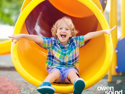Young child at bottom of slide
