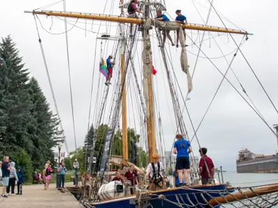Tall sailing ship docked in Owen Sound with people on it